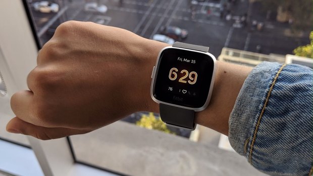 A picture of a wrist with a smartwatch on it